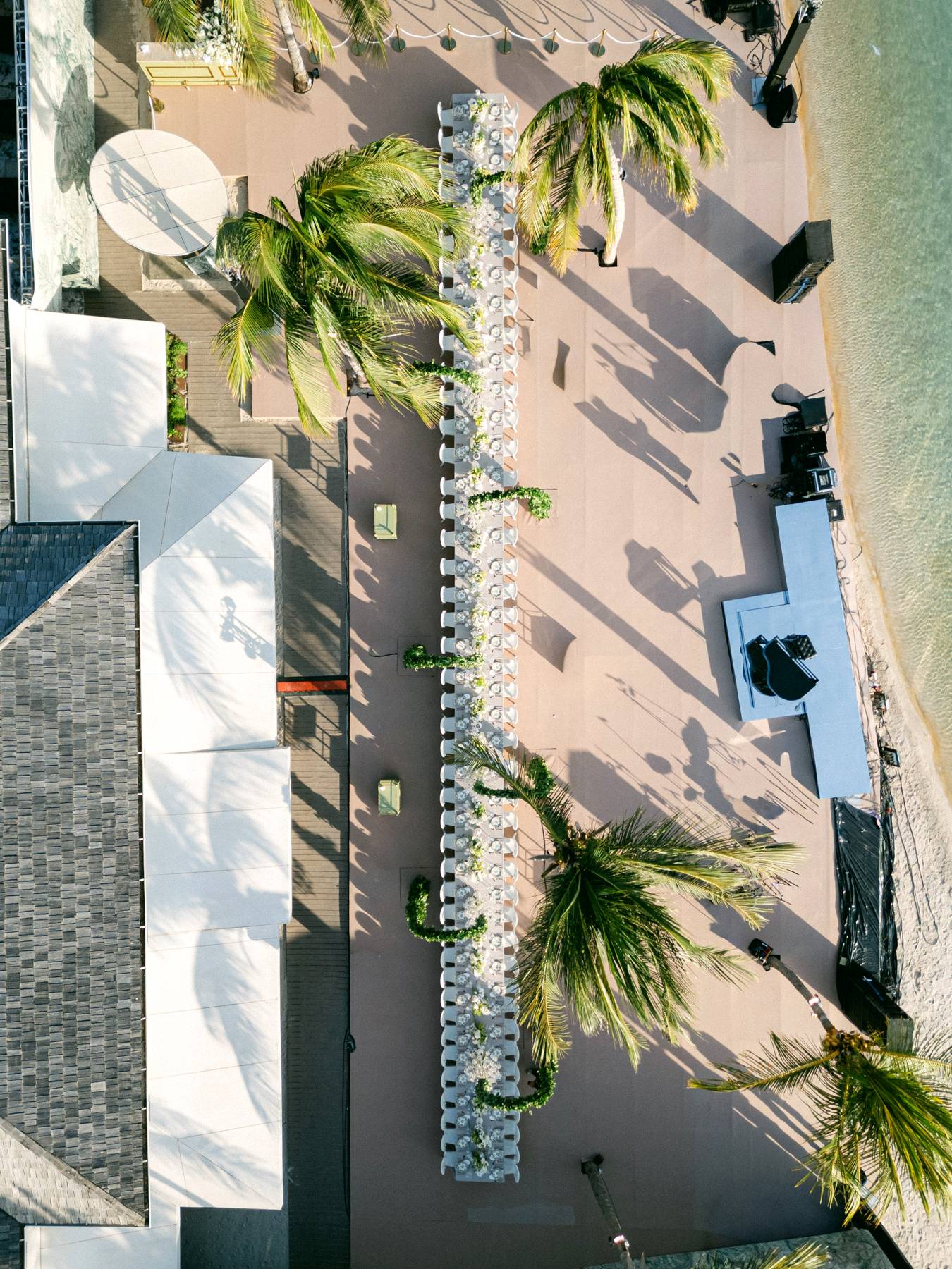 Aerial view of a long-table beach wedding dinner by the sea, Curacao