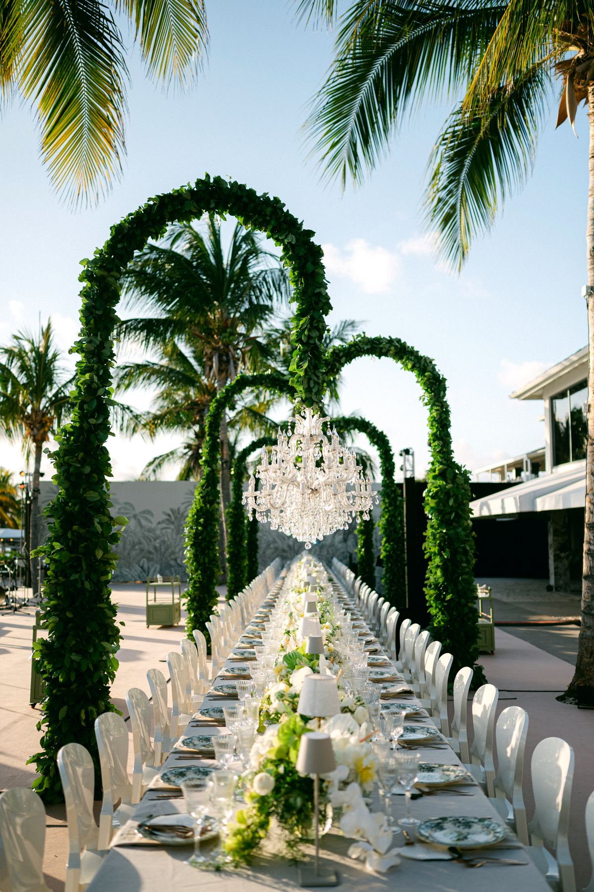 Detail of two crystal chandeliers glowing above a wedding dinner at night, Curacao